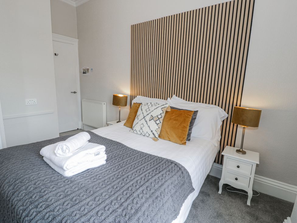 A bedroom with a bed and nightstand at The Keep in Llandudno