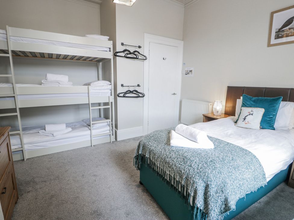 A bedroom with a bunk bed and a double bed at The Keep in Llandudno