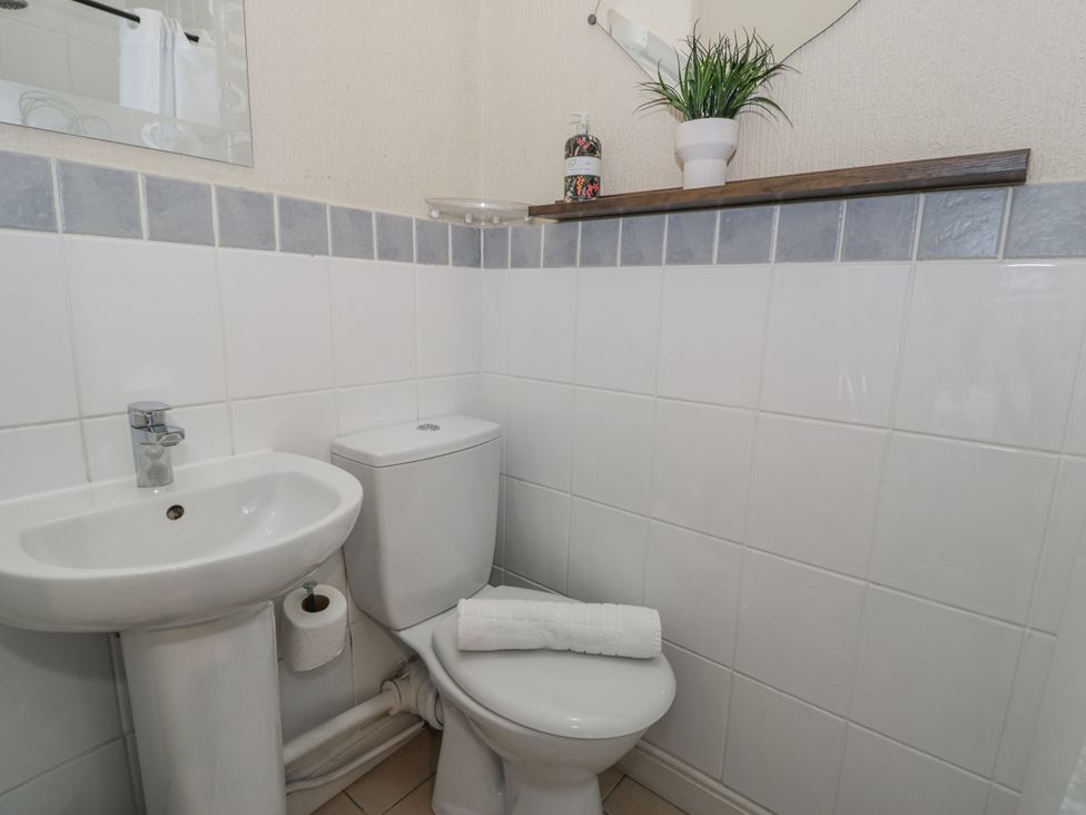 A bathroom featuring a sink and toilet at The Keep in Llandudno
