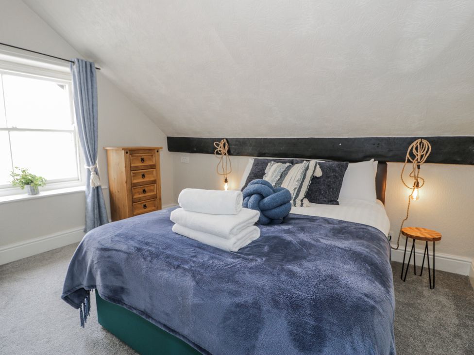 A bedroom with a bed and drawers at The Keep in Llandudno