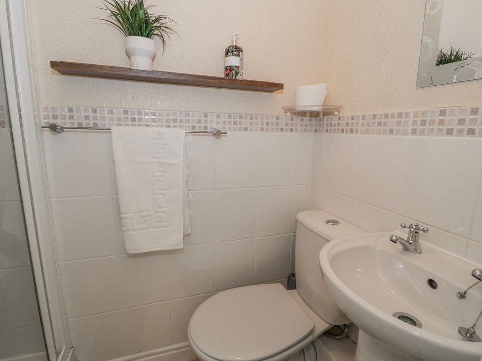 A bathroom with a toilet and sink at The Keep in Llandudno