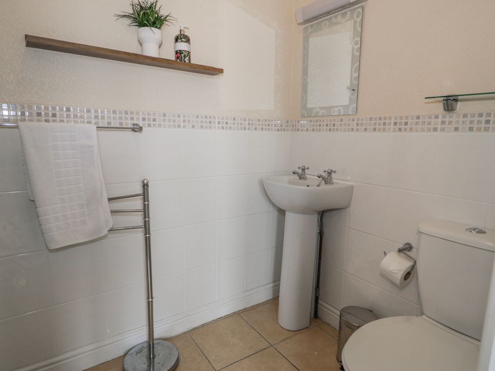 A bathroom with a wash basin and toilet at The Keep in Llandudno
