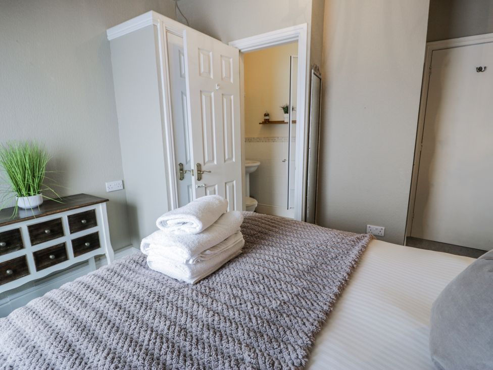 A bedroom with towels on a bed at The Keep in Llandudno