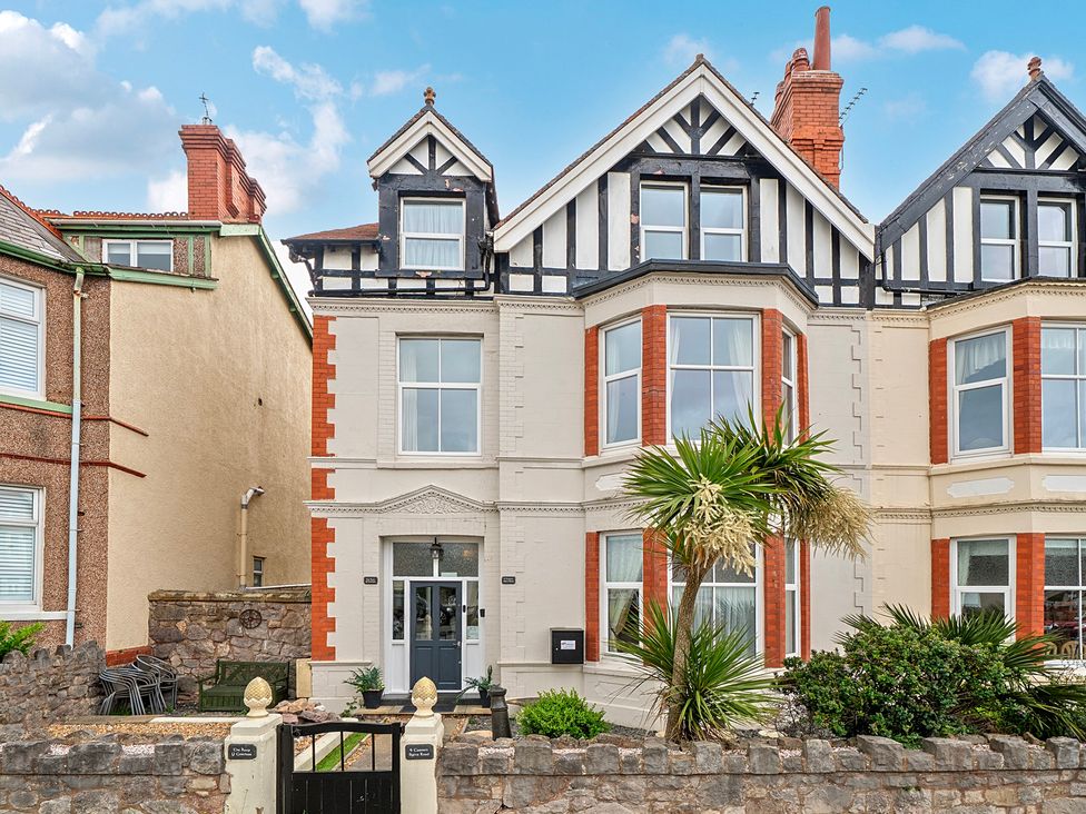 A house with palm trees and windows at The Keep in Llandudno
