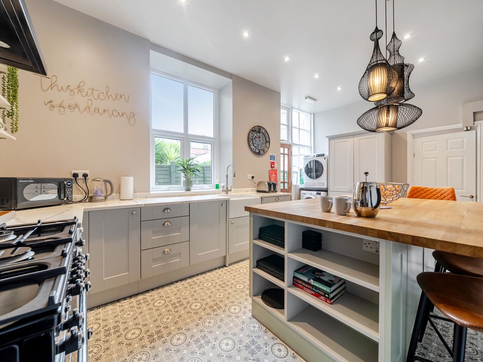 A kitchen with appliances and storage at The Keep in Llandudno