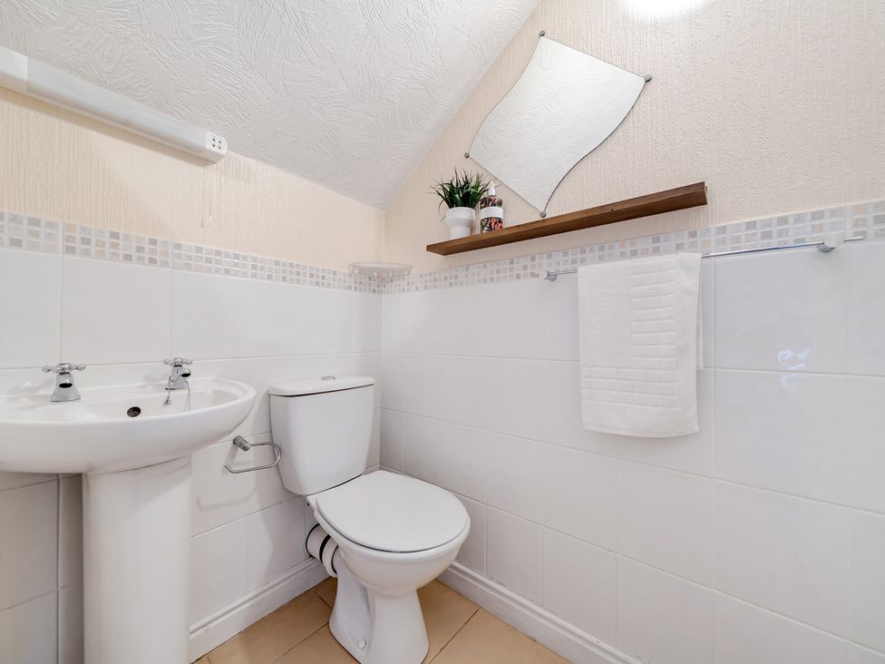 A bathroom with a sink and toilet at The Keep in Llandudno