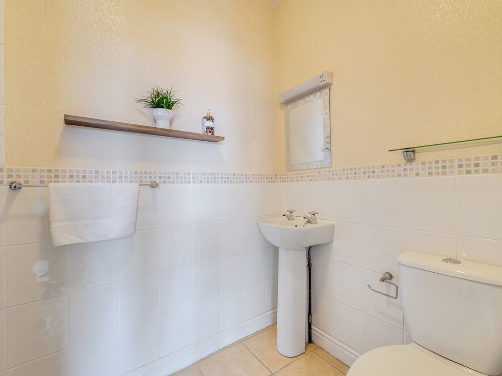 A bathroom with a toilet and sink at The Keep in Llandudno