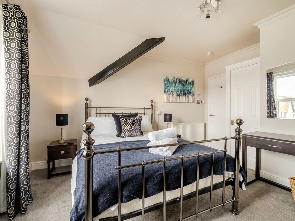 A bedroom with a bed and bedside table at The Keep in Llandudno