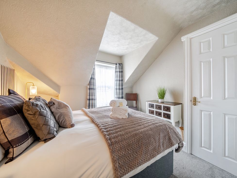 A bedroom with a bed and a window at The Keep in Llandudno