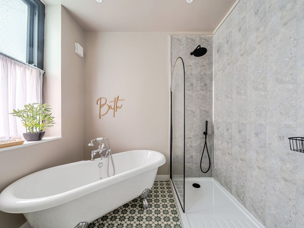 A bathroom with a bathtub and shower at The Keep in Llandudno