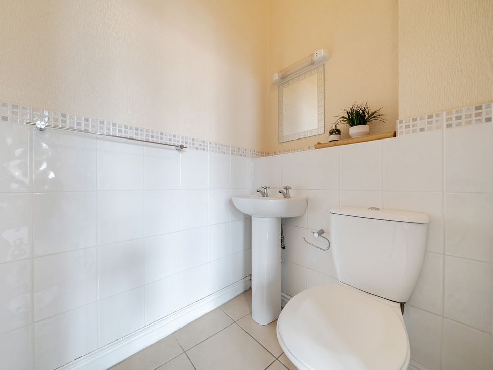 A bathroom with a sink and toilet at The Keep Llandudno