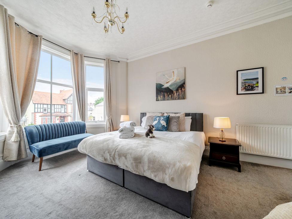 A bedroom with a bed and a sofa at The Keep in Llandudno