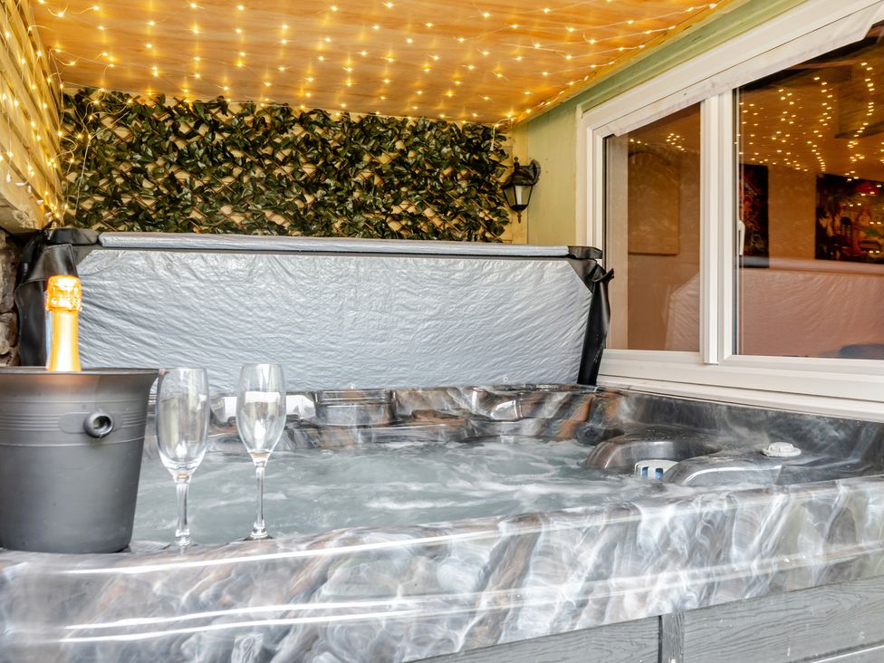 A hot tub with champagne and glasses at The Keep Llandudno