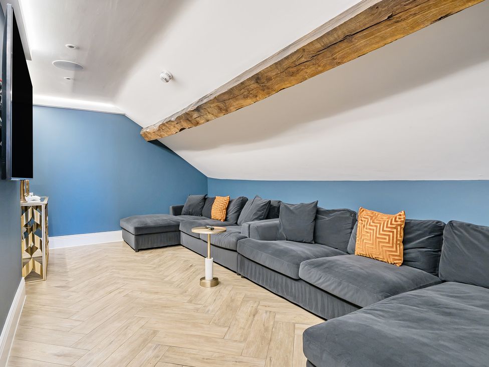 A living room with a sectional sofa and a coffee table at Otherton Hall in Penkridge
