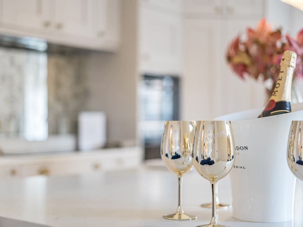A kitchen with champagne and wine glasses at Otherton Hall Penkridge
