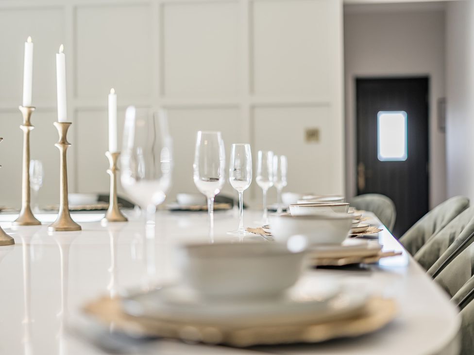 A dining room with a table set for dinner at Otherton Hall in Penkridge