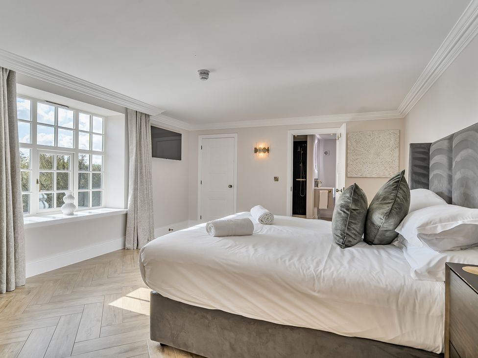 A bedroom with a bed and a window at Otherton Hall in Penkridge