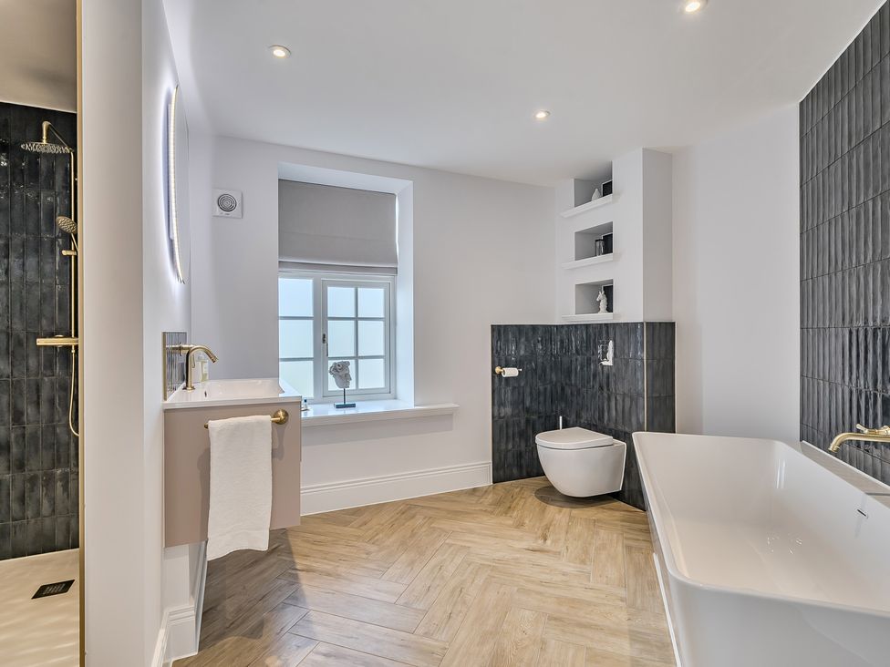 A bathroom with a bathtub, sink, and shower at Otherton Hall Penkridge