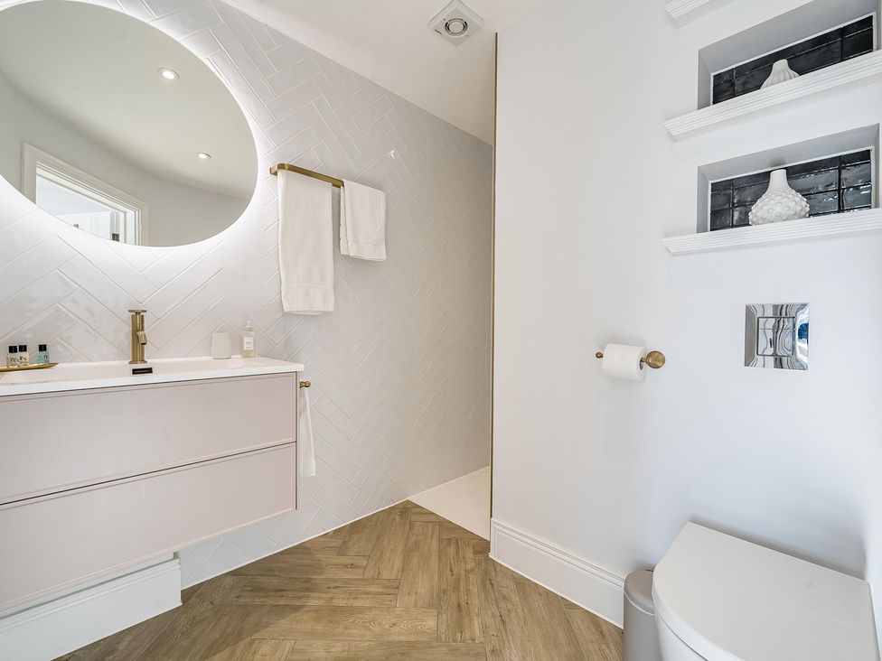 A bathroom with a sink and mirror at Otherton Hall in Penkridge