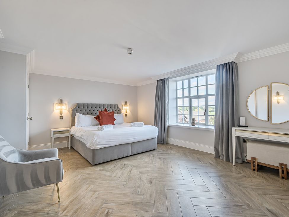 A bedroom with a bed and window at Otherton Hall Penkridge