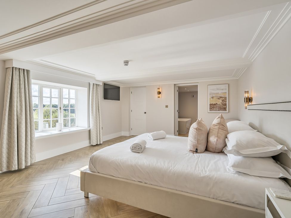 A bedroom with a bed and pillows at Otherton Hall Penkridge