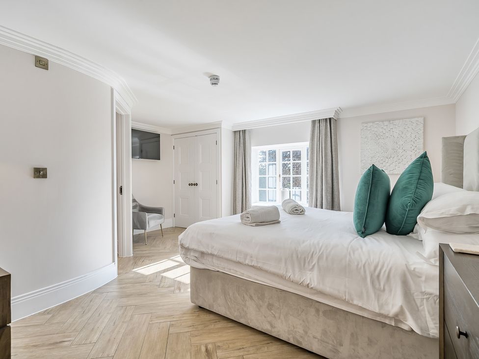 A bedroom with a bed and TV at Otherton Hall in Penkridge