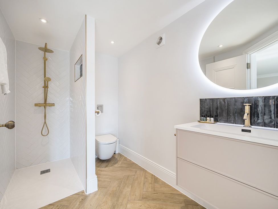 A bathroom with a shower, toilet, and sink at Otherton Hall in Penkridge