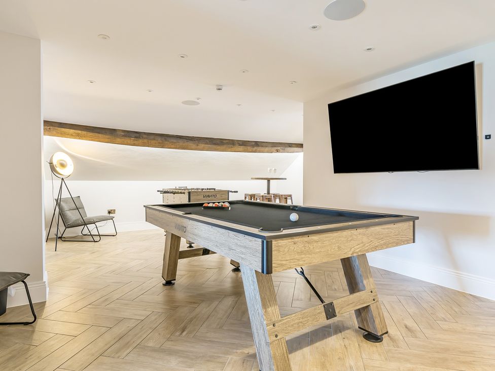 A game room with a pool table and television at Otherton Hall in Penkridge