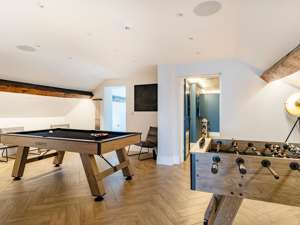 A game room with a pool table and foosball table at Otherton Hall in Penkridge