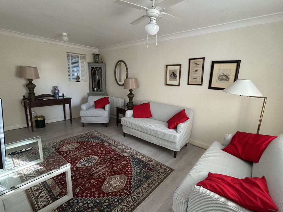 A living room with sofas, coffee table and artwork at The White House in Torquay