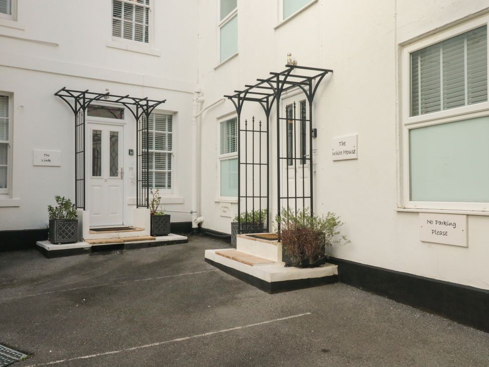 An outdoor area with entrances and signage at The White House in Torquay