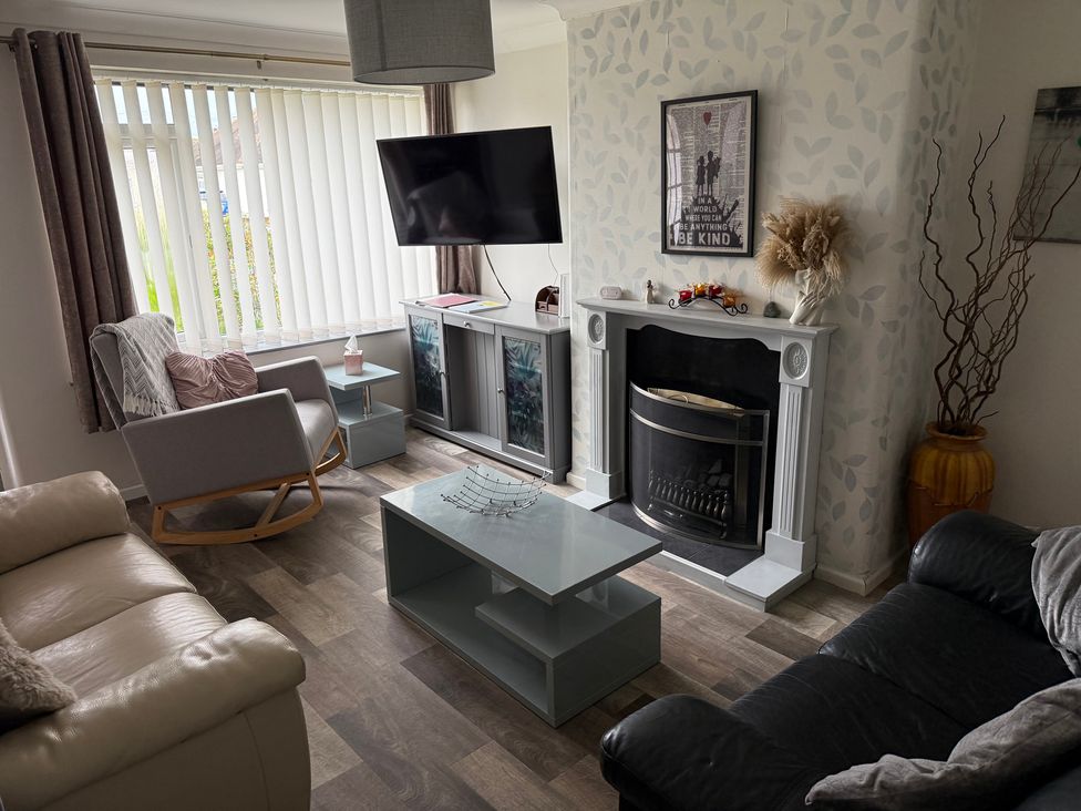 A living room with a sofa and armchair at Bungalow by the Sea Cleveleys