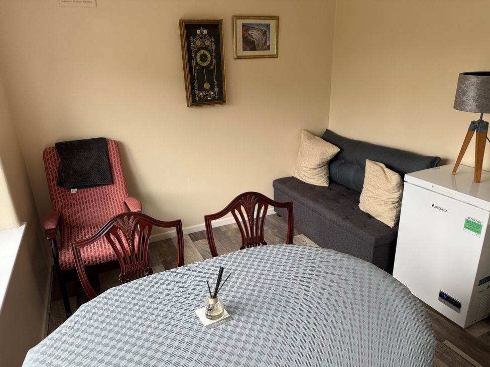 A sitting room with a dining table and chairs at Bungalow by the Sea in Cleveleys