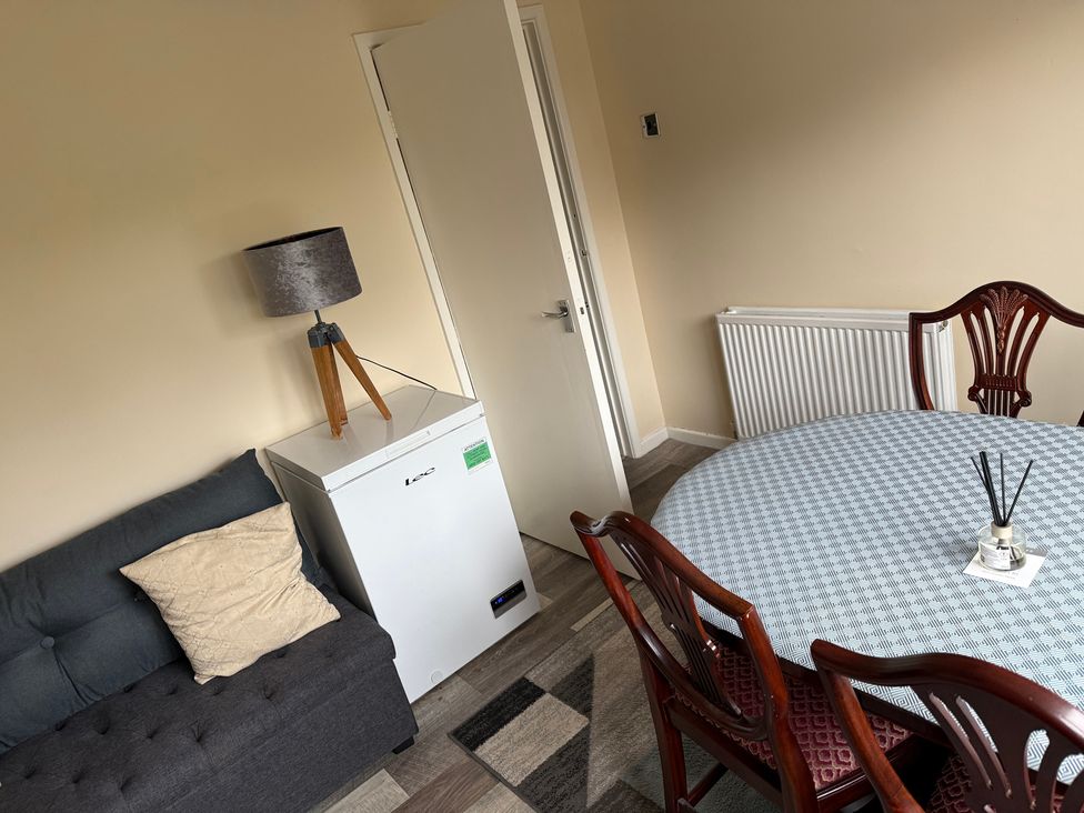 A dining room with a table and chairs at Bungalow by the Sea in Cleveleys