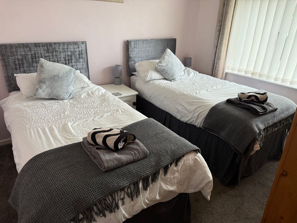 A bedroom with two single beds at Bungalow by the Sea Cleveleys