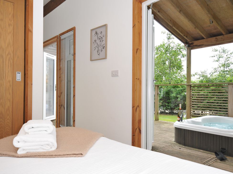 A bedroom with a hot tub visible from the sliding door at 3 Southern Place in Dobwalls