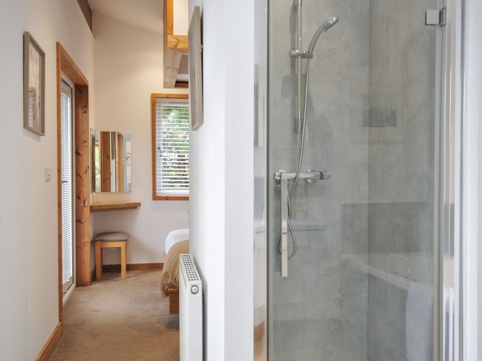 A bathroom with a shower and a mirror at 3 Southern Place in Dobwalls