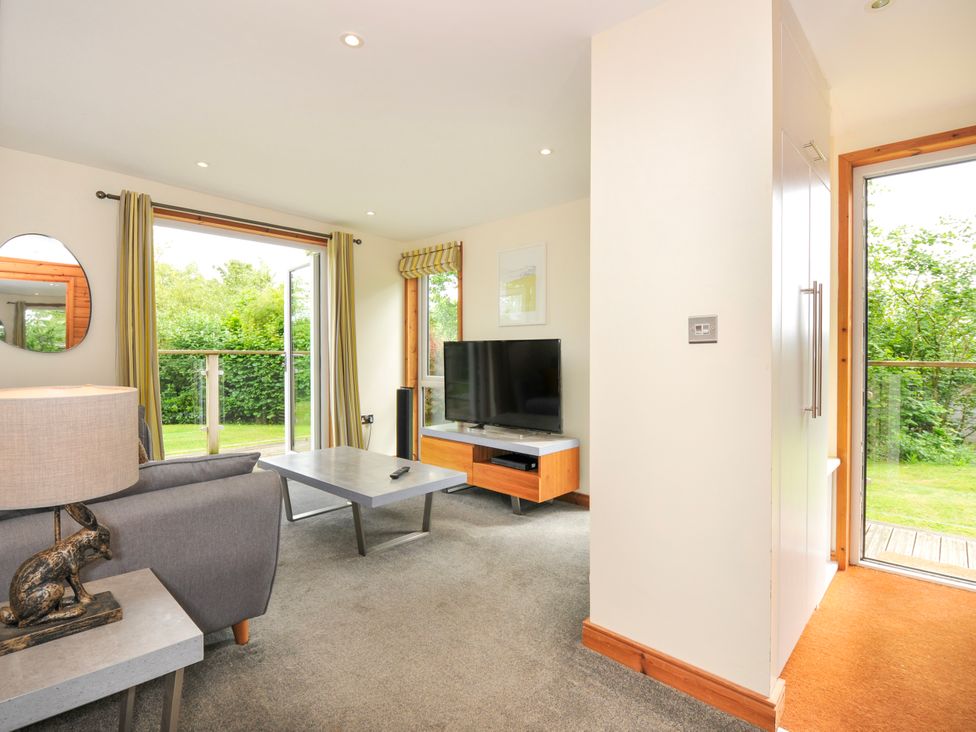 A living room with a television and sofa at 5 Faraway Fields in Dobwalls