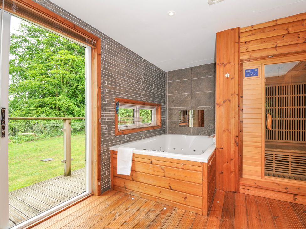 A bathroom with a jacuzzi and sauna at 5 Faraway Fields in Dobwalls