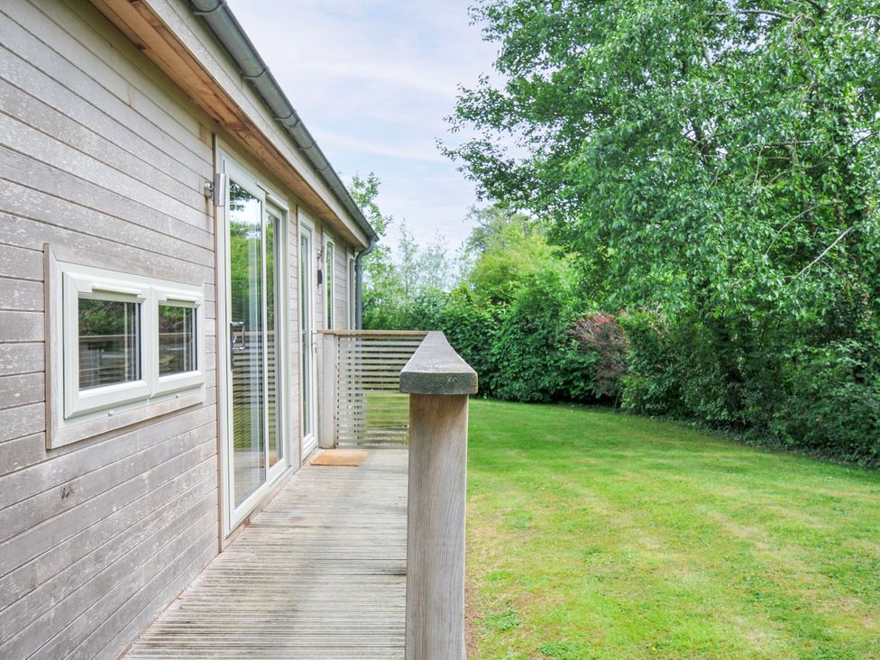 An outdoor area with a wooden deck and grass at 5 Faraway Fields in Dobwalls