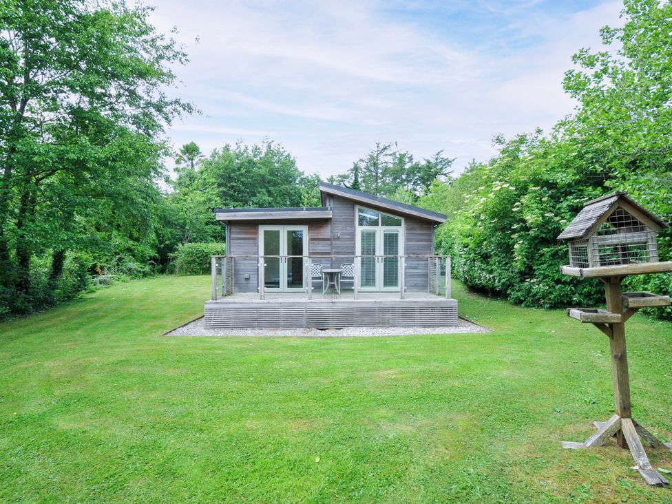 A house with a deck and bird feeder at 5 Faraway Fields in Dobwalls