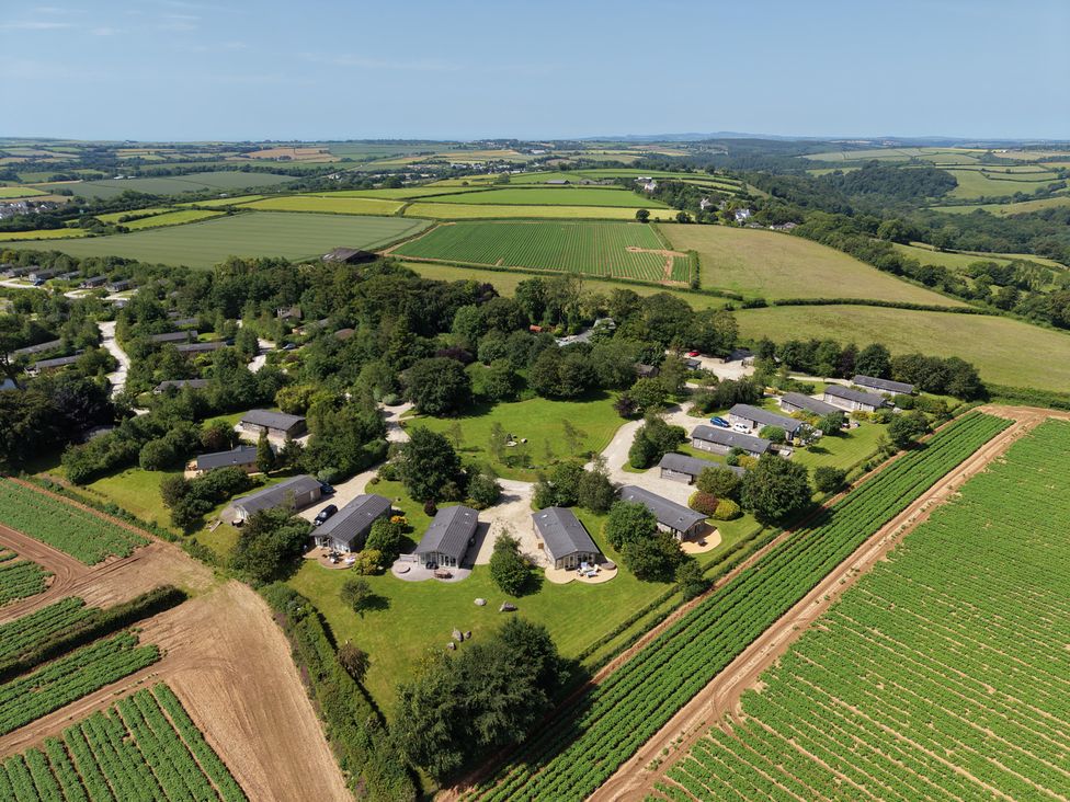 An aerial view of a cabin site surrounded by fields at 12 Faraway Fields in Dobwalls