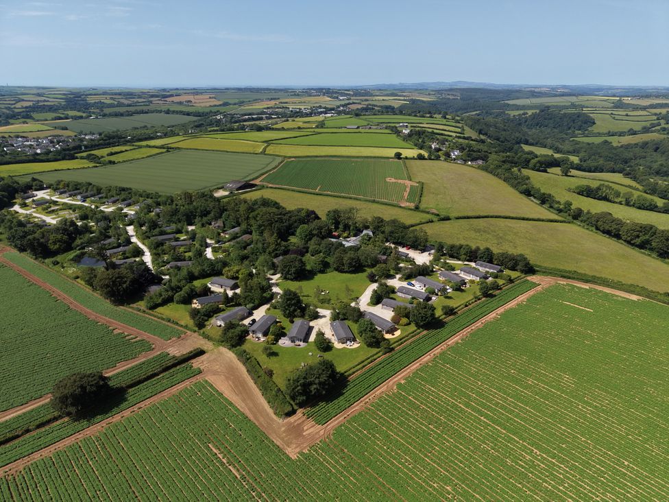 A residential area with buildings and fields at 12 Faraway Fields in Dobwalls
