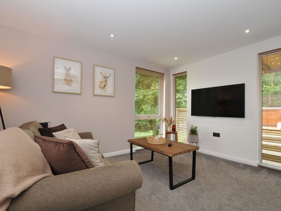 A living room with a sofa and coffee table at 24 Meadow Retreat in Dobwalls
