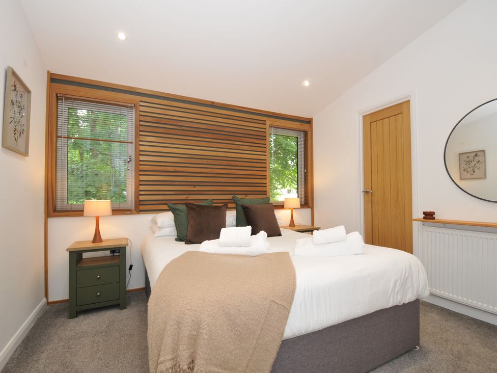 A bedroom with a bed and nightstand at 24 Meadow Retreat Dobwalls