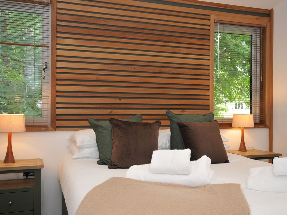A bed with pillows and blankets at 24 Meadow Retreat in Dobwalls