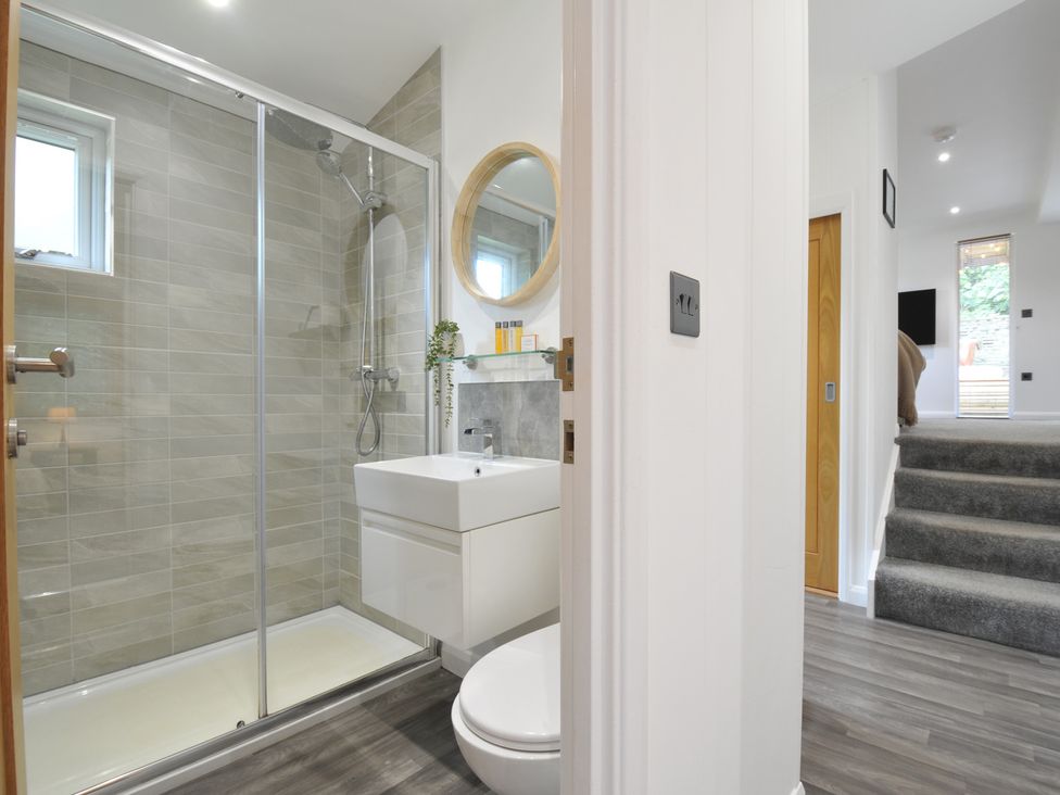 A bathroom with a shower, sink, and toilet at 24 Meadow Retreat in Dobwalls
