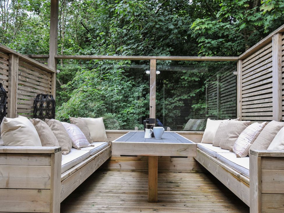 An outdoor seating area with benches and a table at 24 Meadow Retreat in Dobwalls