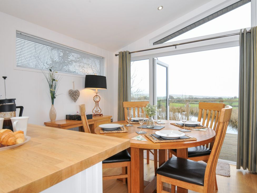 A dining room with a round table and chairs at 15 Faraway Fields in Dobwalls