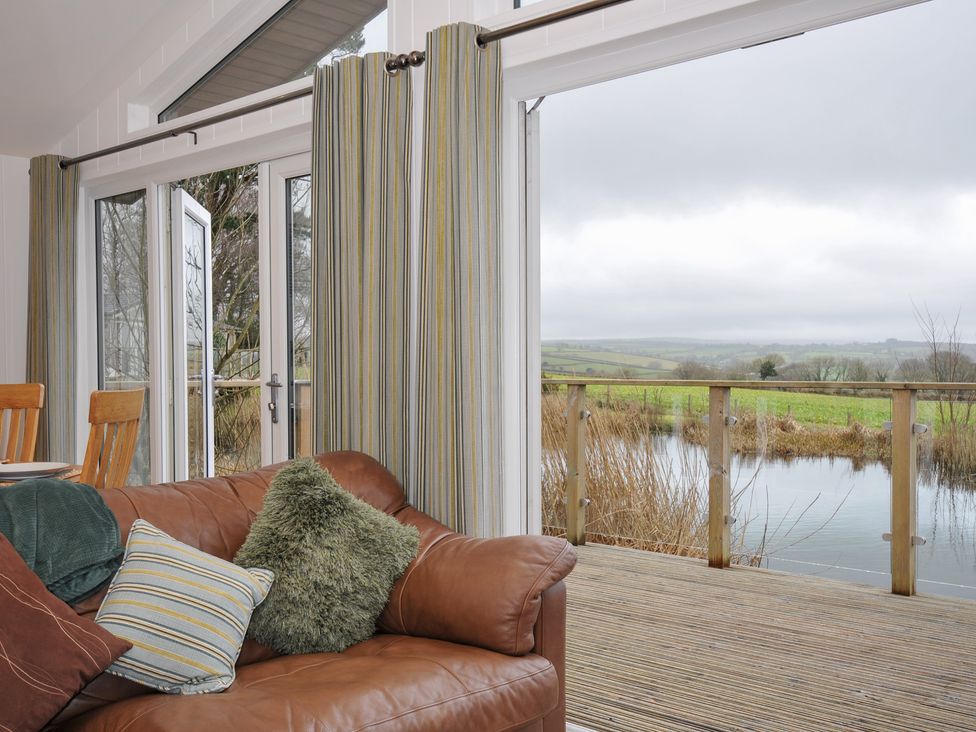 A living room with a sofa and dining table at 15 Faraway Fields in Dobwalls